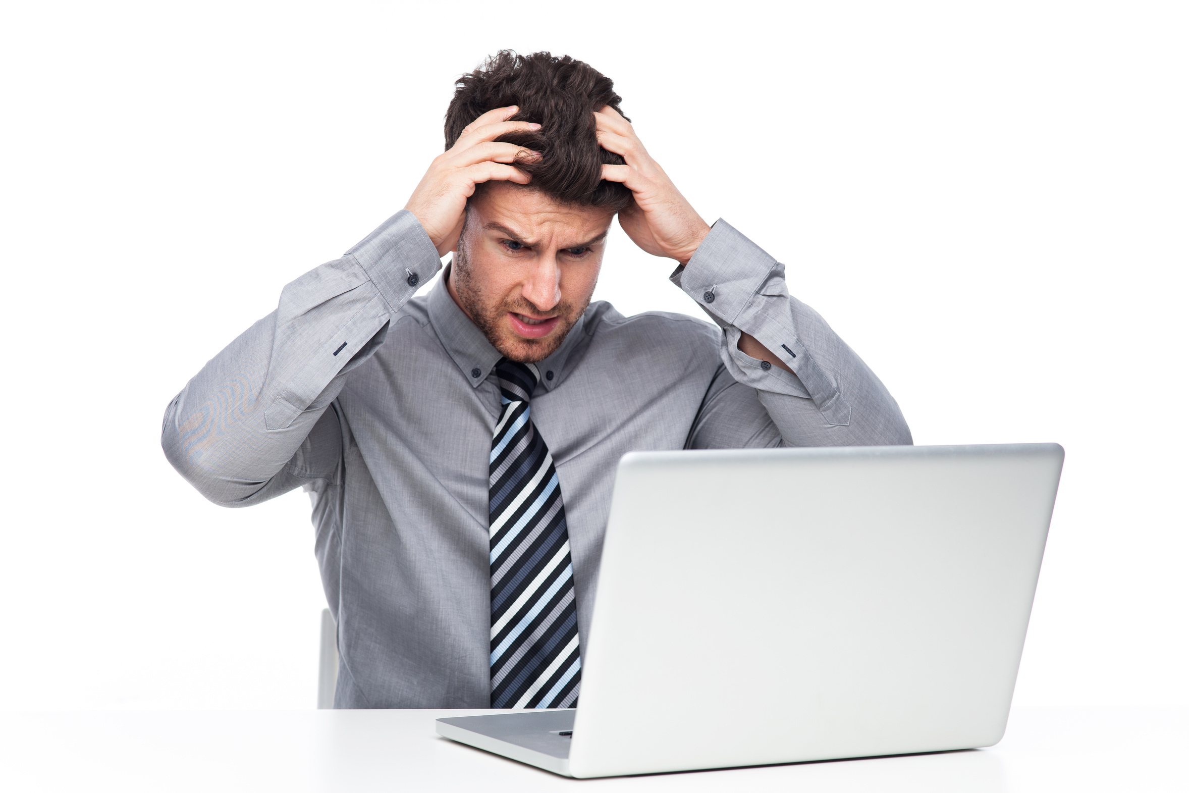 Stressed man looking at laptop